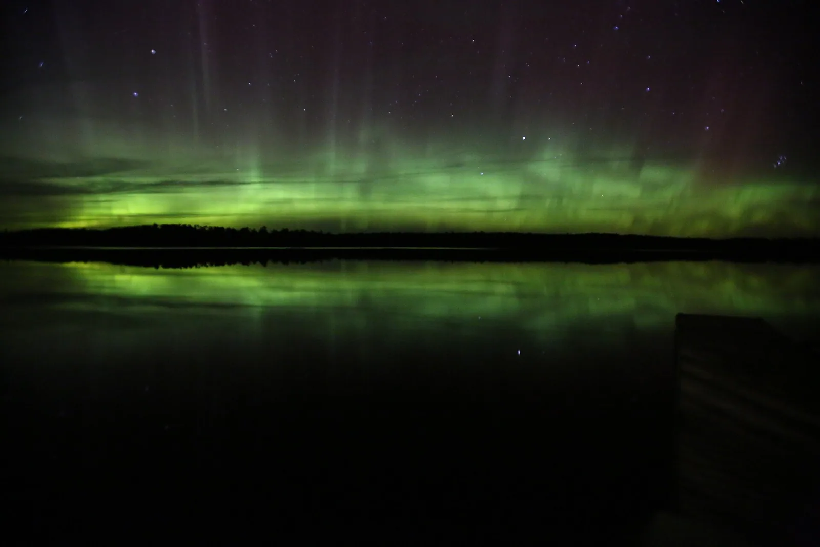Northern lights and stars reflected on a lake in Voyageurs National Park